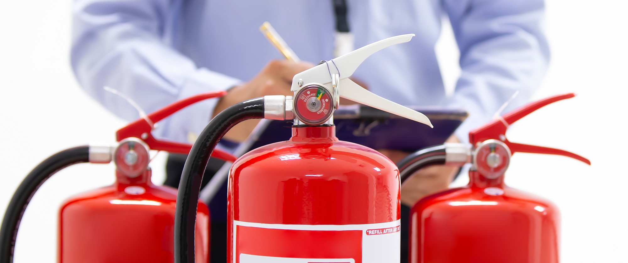 Man inspecting fire estinguishers