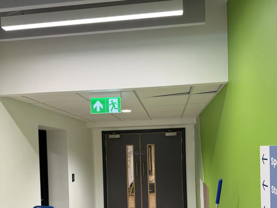 A corridor leading to fire exit doors
